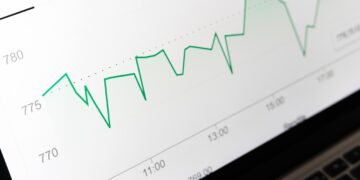 Bilgisayar ekranında dalgalı yeşil çizgi grafik ve veriler görünüyor