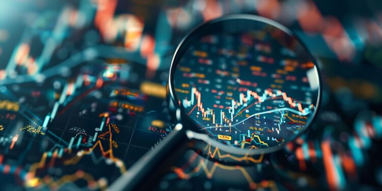 Büyüteç altındaki finansal grafikler ve hisse senedi piyasası verileri.