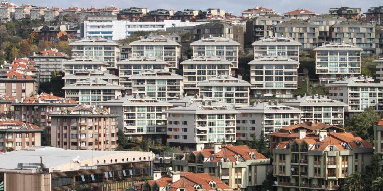 İstanbul'daki yoğun yapılaşmayı ve birbirine yakın modern apartman bloklarını gösteren dış mekan çekimi.