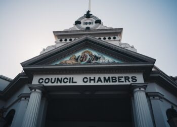 Üzerinde Council Chambers yazan tarihi bir belediye binası girişi.